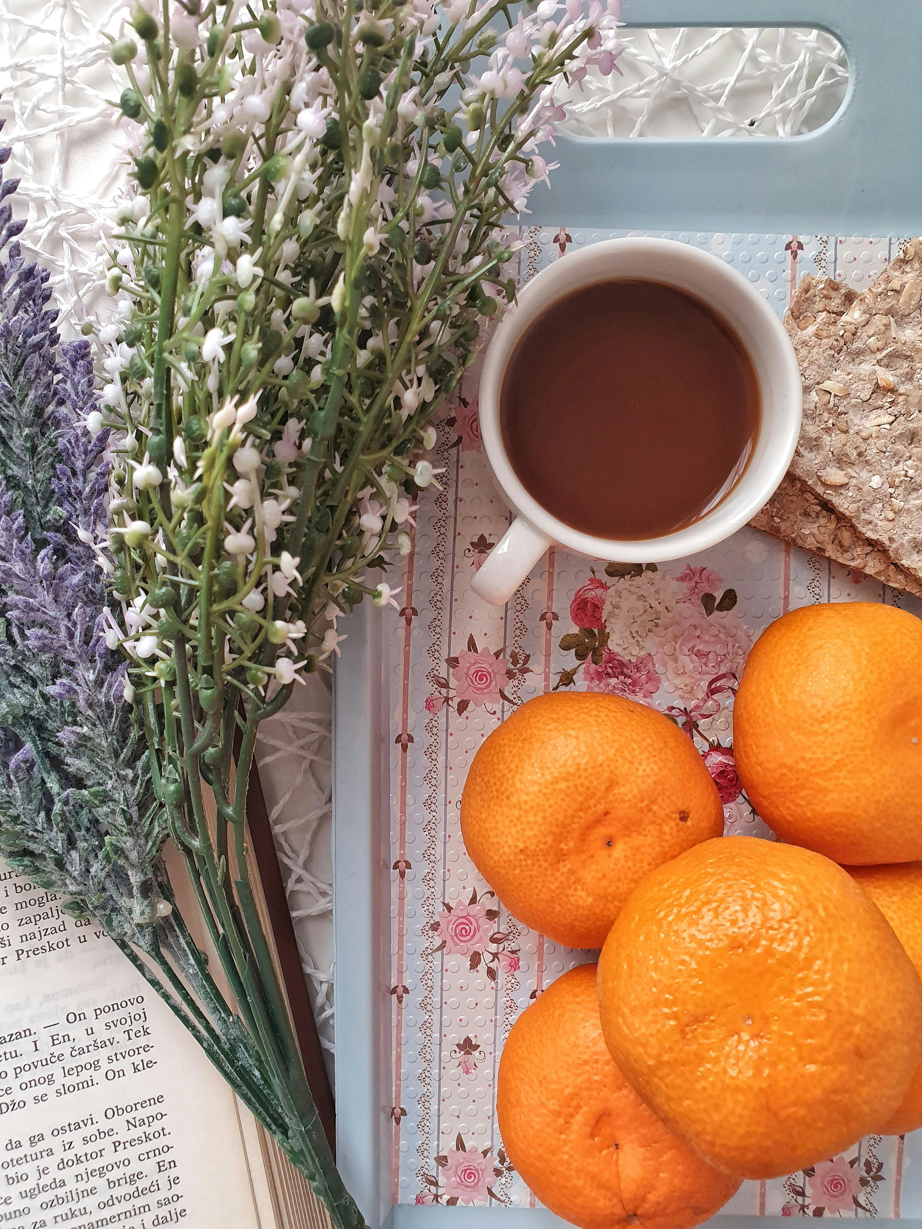 Lavender, coffee cup with coffee, oranges, crackers