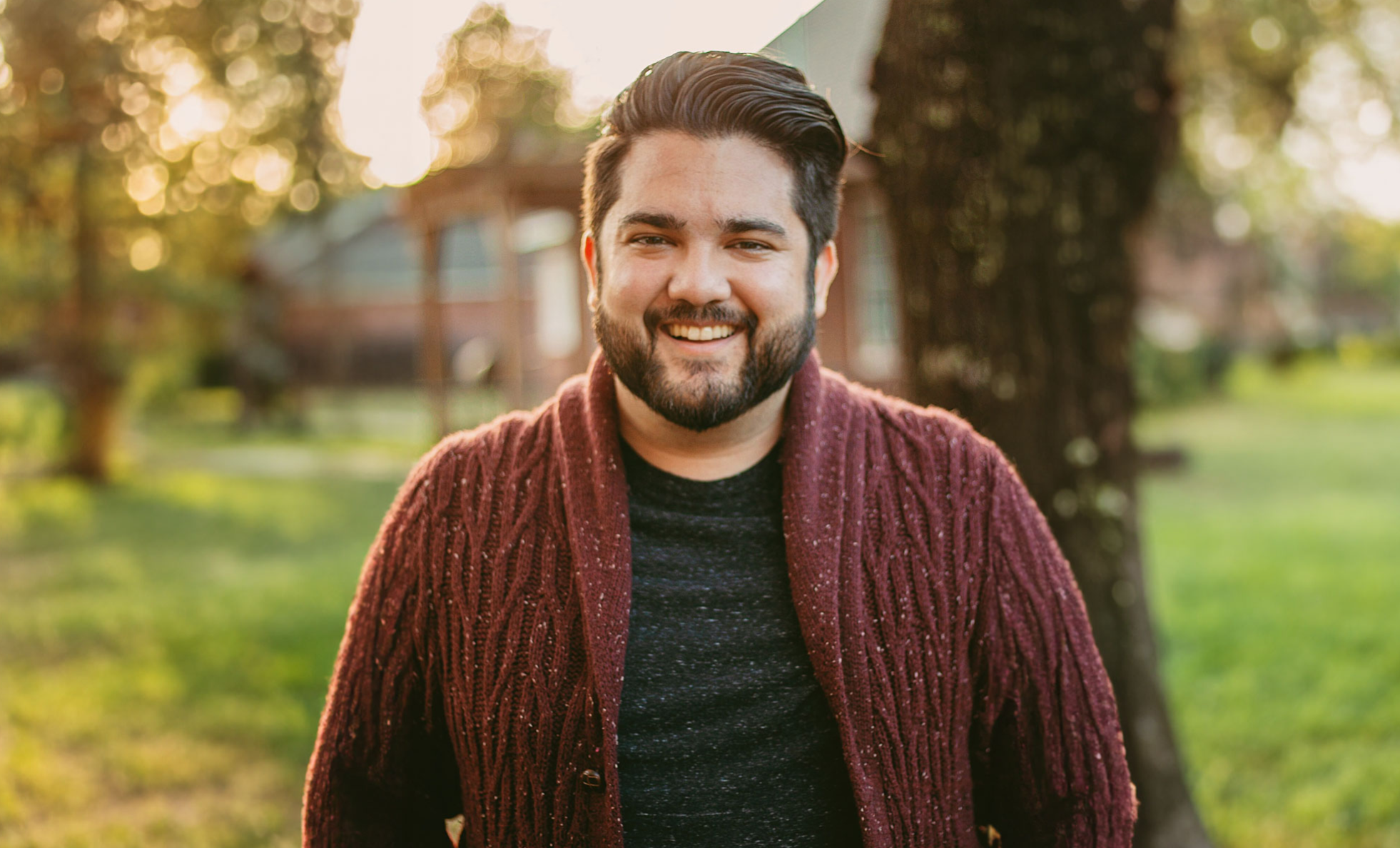 picture of Josh Frederick, man with a green shirt and sweater, beard